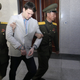 Warmbier is half-carried by North Korean officials into his trial. Image via AP.